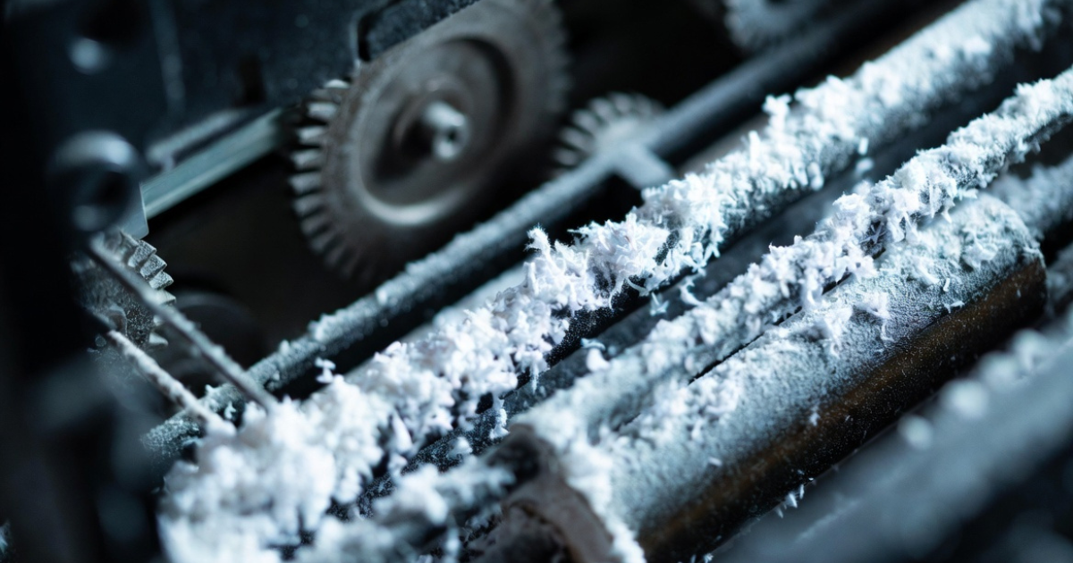 Low quality paper dust buildup inside printer causing paper jams