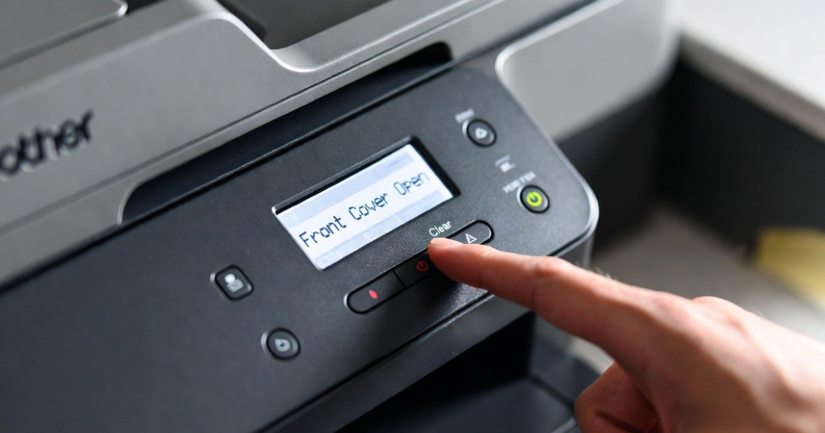 Pressing clear button on Brother printer control panel to reset toner message